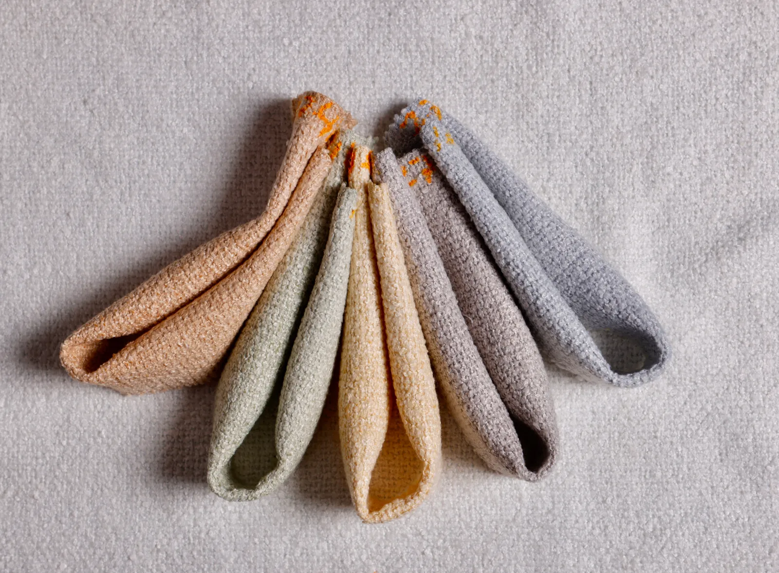 Side-by-side comparison of polyester and cotton yarn samples for upholstery fabric